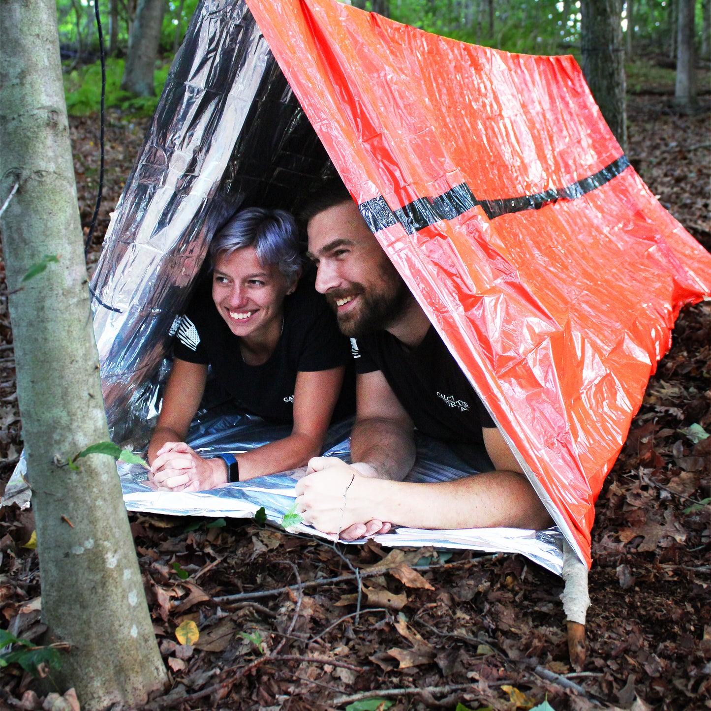 People inside Mylar Emergency Tube Tent