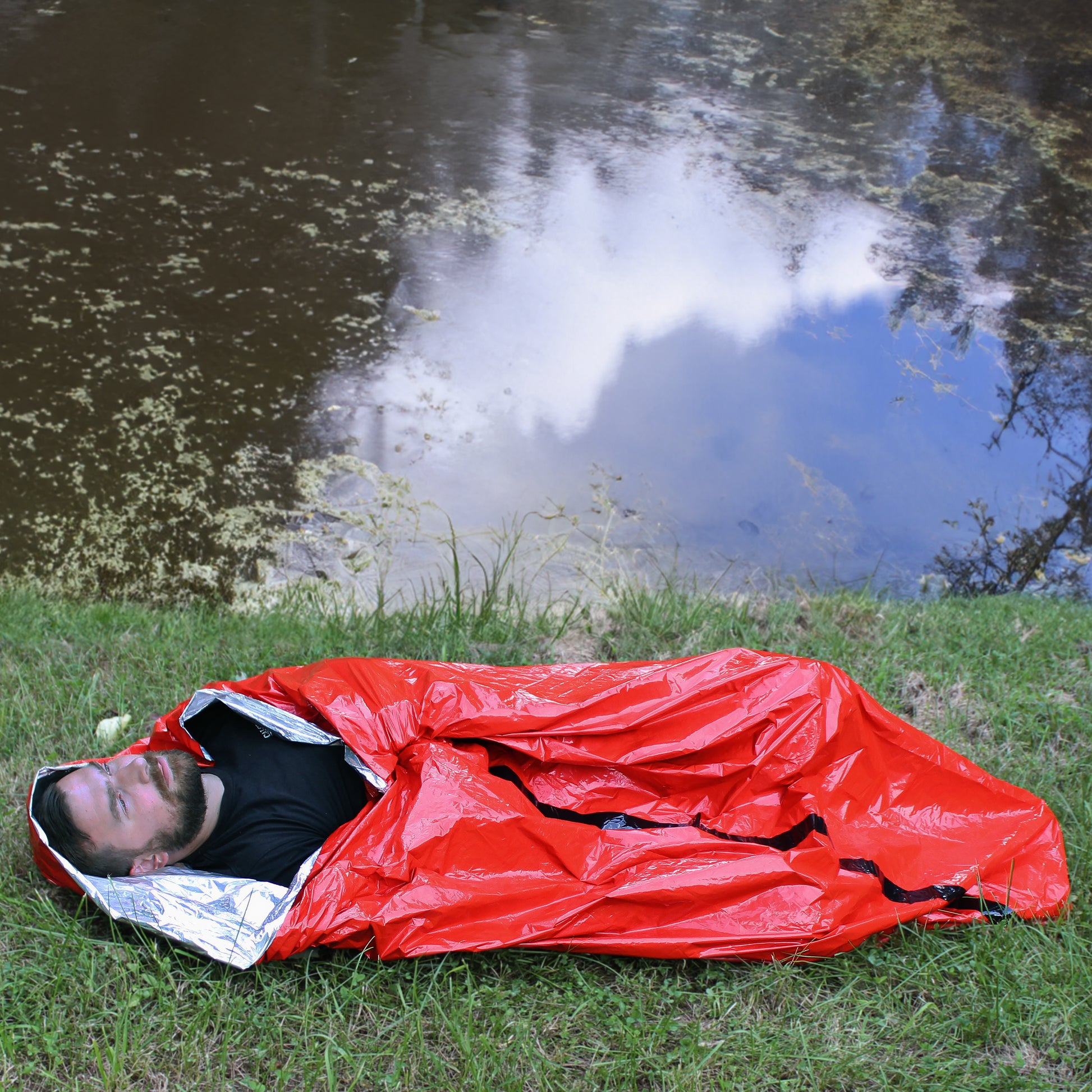 Person sleeping in Mylar Emergency Tube Tent